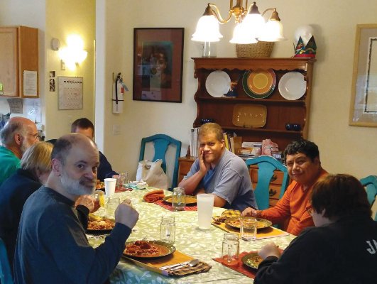 Residents of the home enjoy meals together as well as a host of other activities “like a family,” said Claudia Coppola, executive director for Olympic Neighbors.